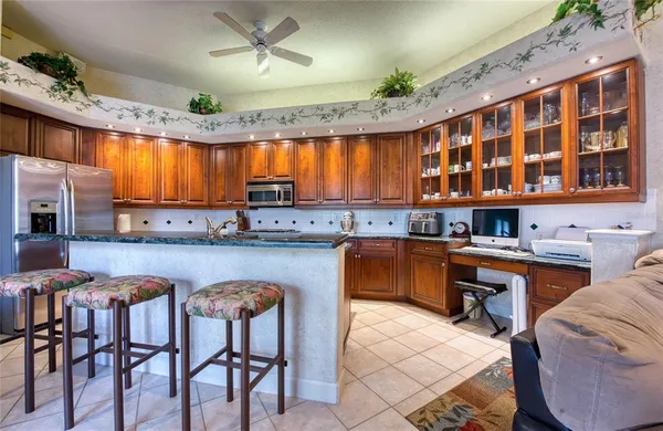 a kitchen with stainless steel appliances granite countertop a stove a sink dishwasher and cabinets with wooden floor