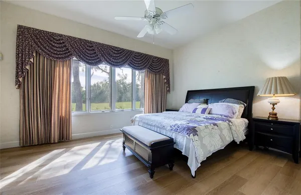 a bedroom with a bed table and a window