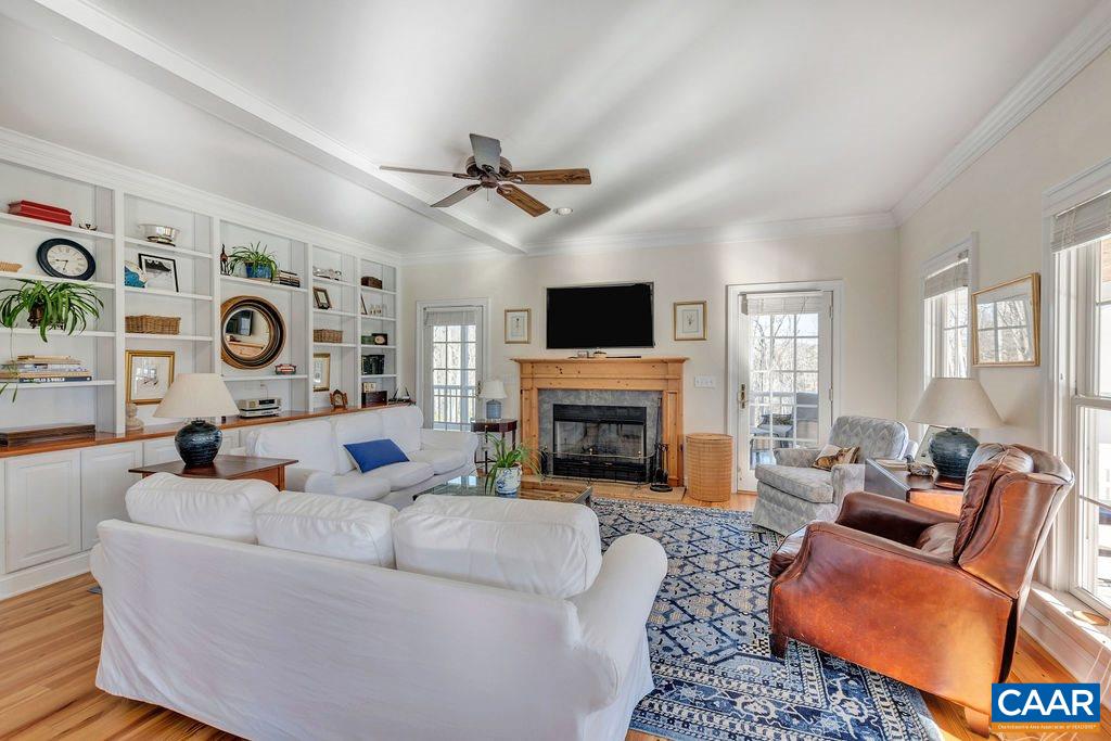 7920 Chestnut Grove Road Esmont, VA 22937 - Photo 2 of 34 a living room with furniture a fireplace and a flat screen tv