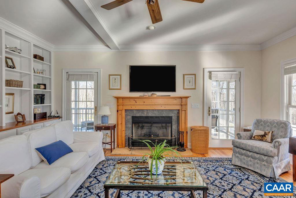 7920 Chestnut Grove Road Esmont, VA 22937 - Photo 4 of 34 a living room with furniture a flat screen tv and a fireplace