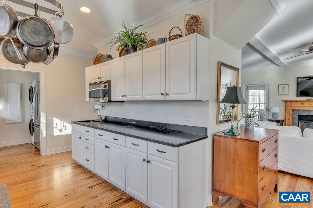 7920 Chestnut Grove Road Esmont, VA 22937 - Photo 5 of 34 a kitchen with stainless steel appliances granite countertop a sink a stove and a wooden floors