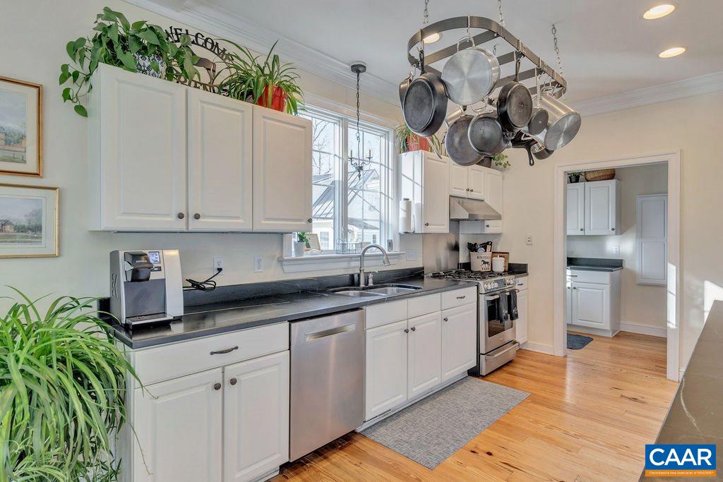 7920 Chestnut Grove Road Esmont, VA 22937 - Photo 6 of 34 a kitchen with stainless steel appliances granite countertop a sink a stove and a wooden floors