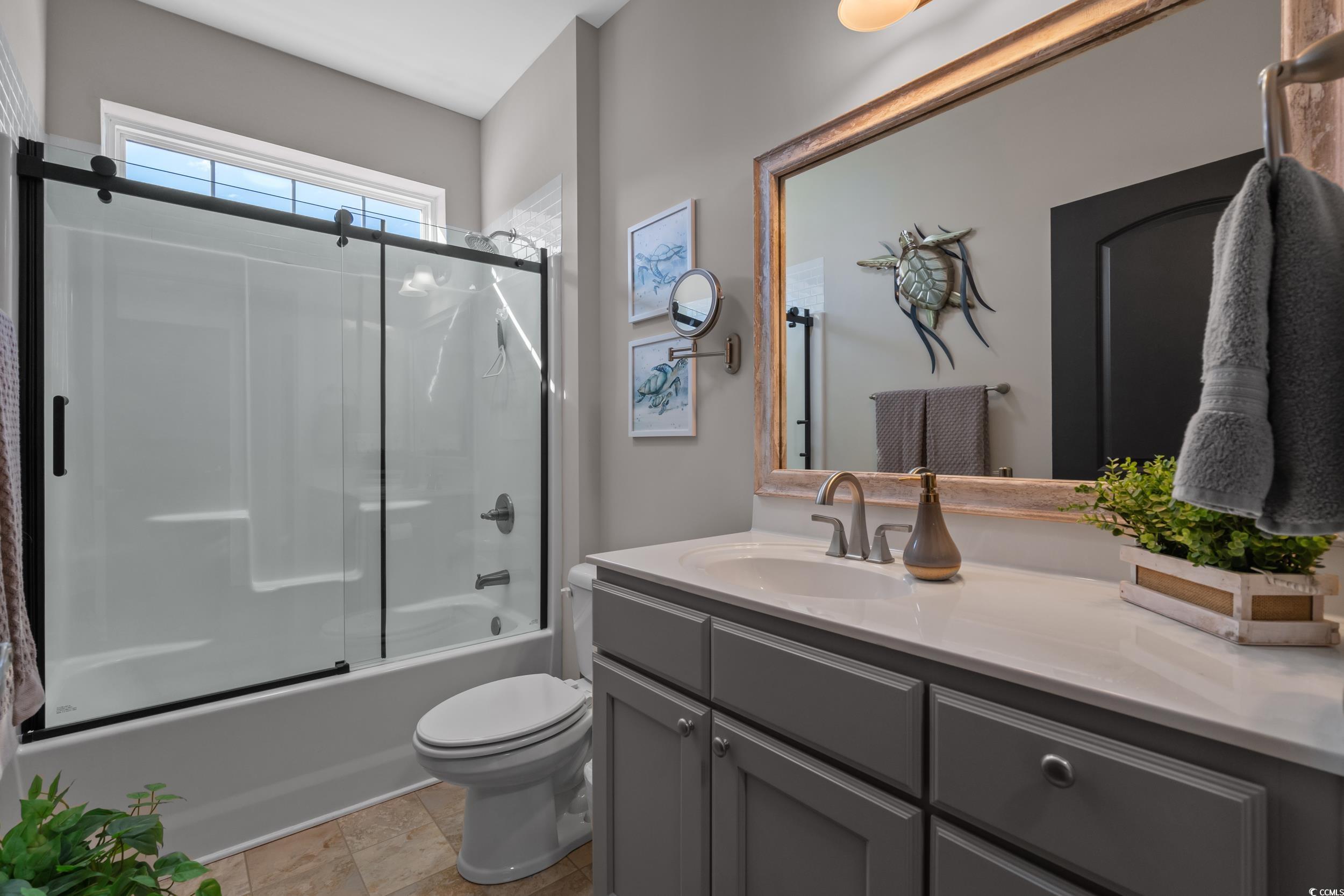 142 Ella Kinley Circle, Unit 304 Myrtle Beach, SC 29588 - Photo 28 of 38 Bathroom featuring combined bath / shower with glass door and vanity