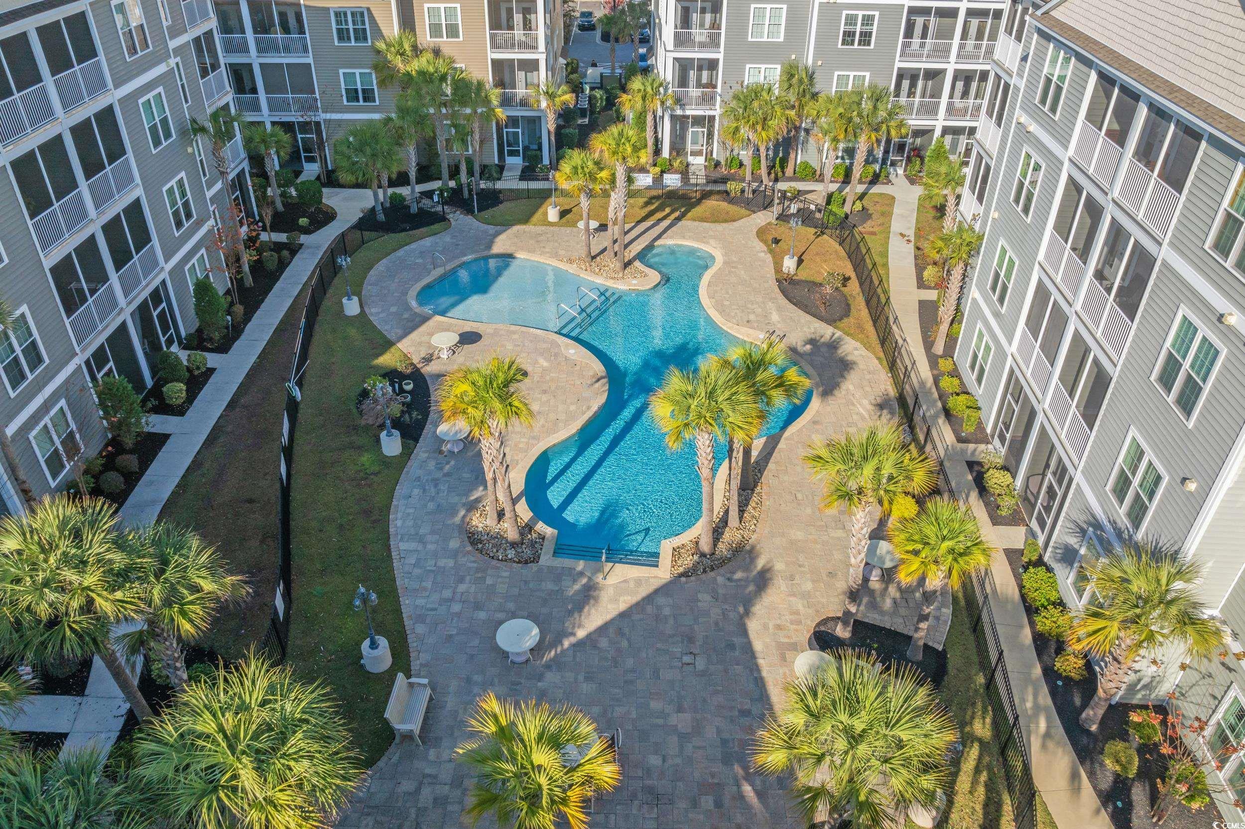 142 Ella Kinley Circle, Unit 304 Myrtle Beach, SC 29588 - Photo 31 of 38 Bird's eye view of a pool and apartment complex