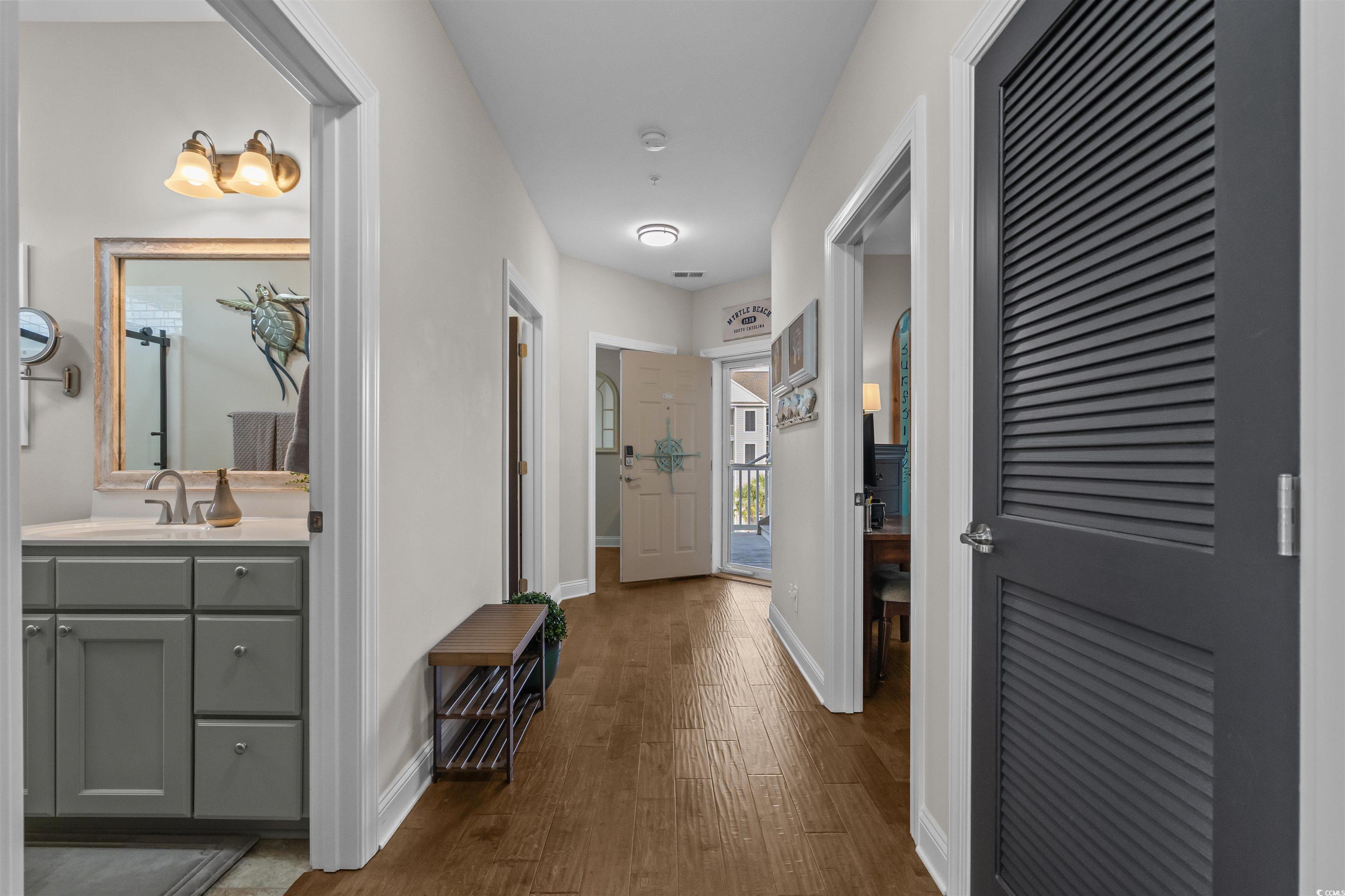 142 Ella Kinley Circle, Unit 304 Myrtle Beach, SC 29588 - Photo 7 of 38 Corridor featuring dark wood-style flooring and baseboards