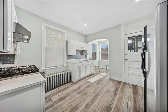 a kitchen with stainless steel appliances a refrigerator and a stove top oven