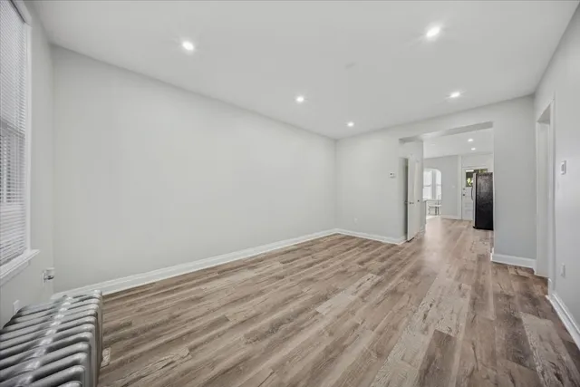 a view of a room with wooden floor and natural light