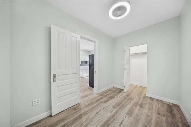 a view of hallway with wooden floor