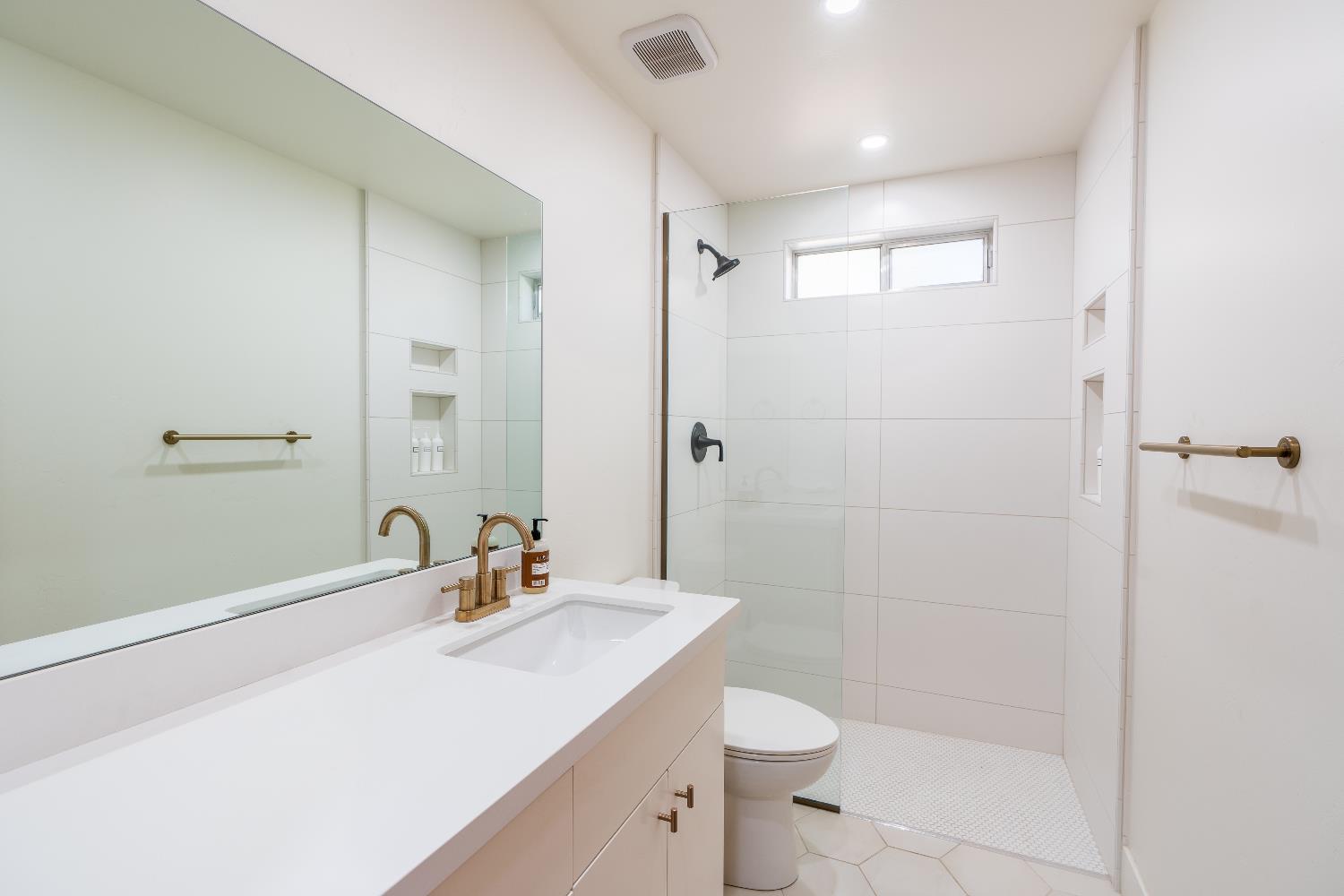 28960 Snowhite Ridge Drive Long Barn, CA 95335 - Photo 9 of 15 a bathroom with a sink a toilet a shower and a mirror