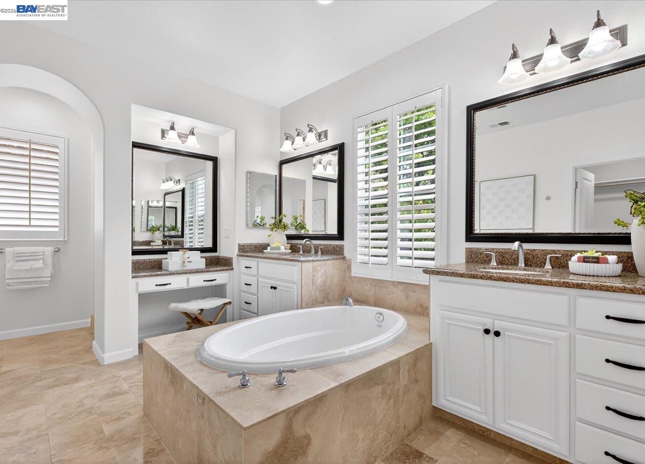 8148 Briar Oaks Drive San Ramon, CA 94582 - Photo 27 of 40 a bathroom with a granite countertop sink mirror and bathtub