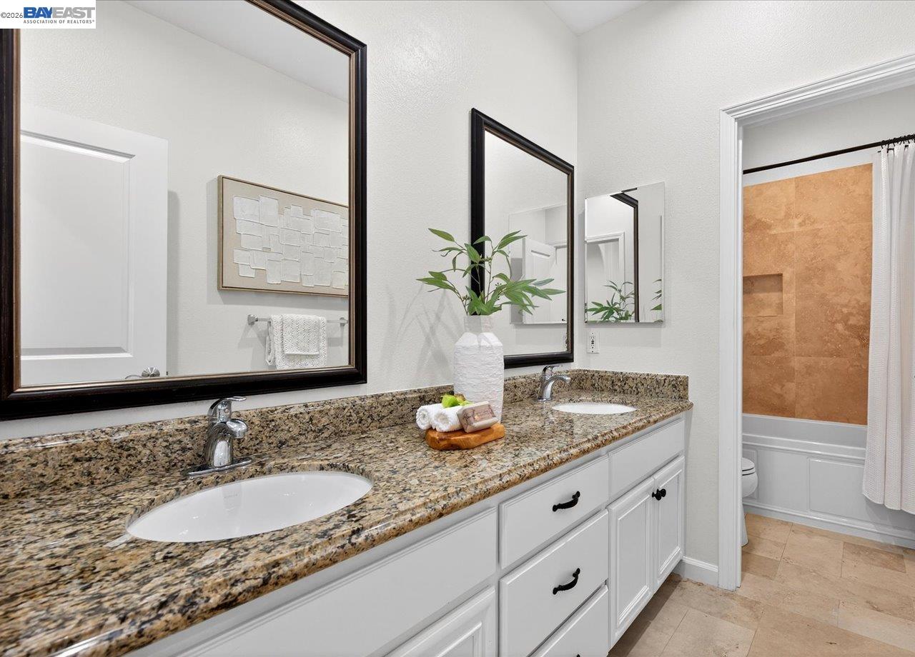 8148 Briar Oaks Drive San Ramon, CA 94582 - Photo 34 of 40 a bathroom with a granite countertop sink and a mirror