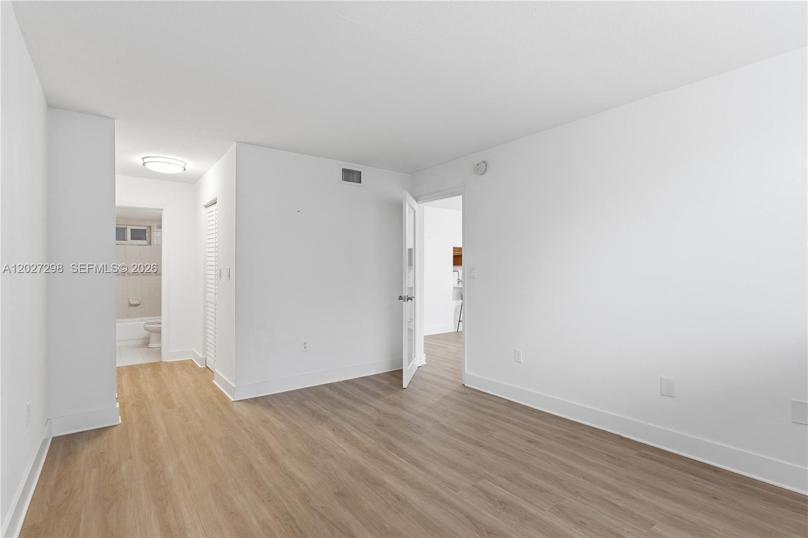 1665 Bay Road, Unit 322 Miami Beach, FL 33139 - Photo 11 of 24 wooden floor in an empty room