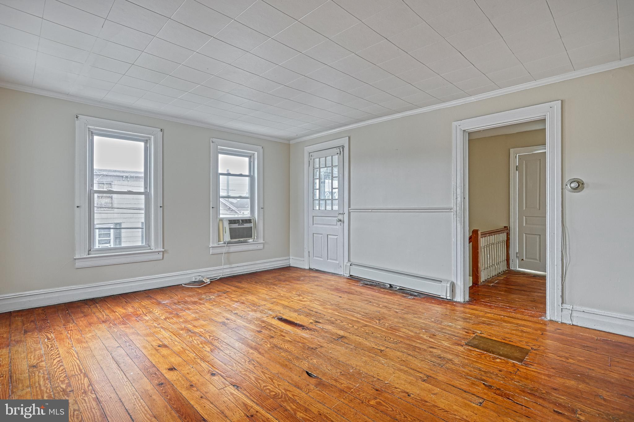 3 North Water Street Spring Grove, PA 17362 - Photo 27 of 52 an empty room with wooden floor and windows