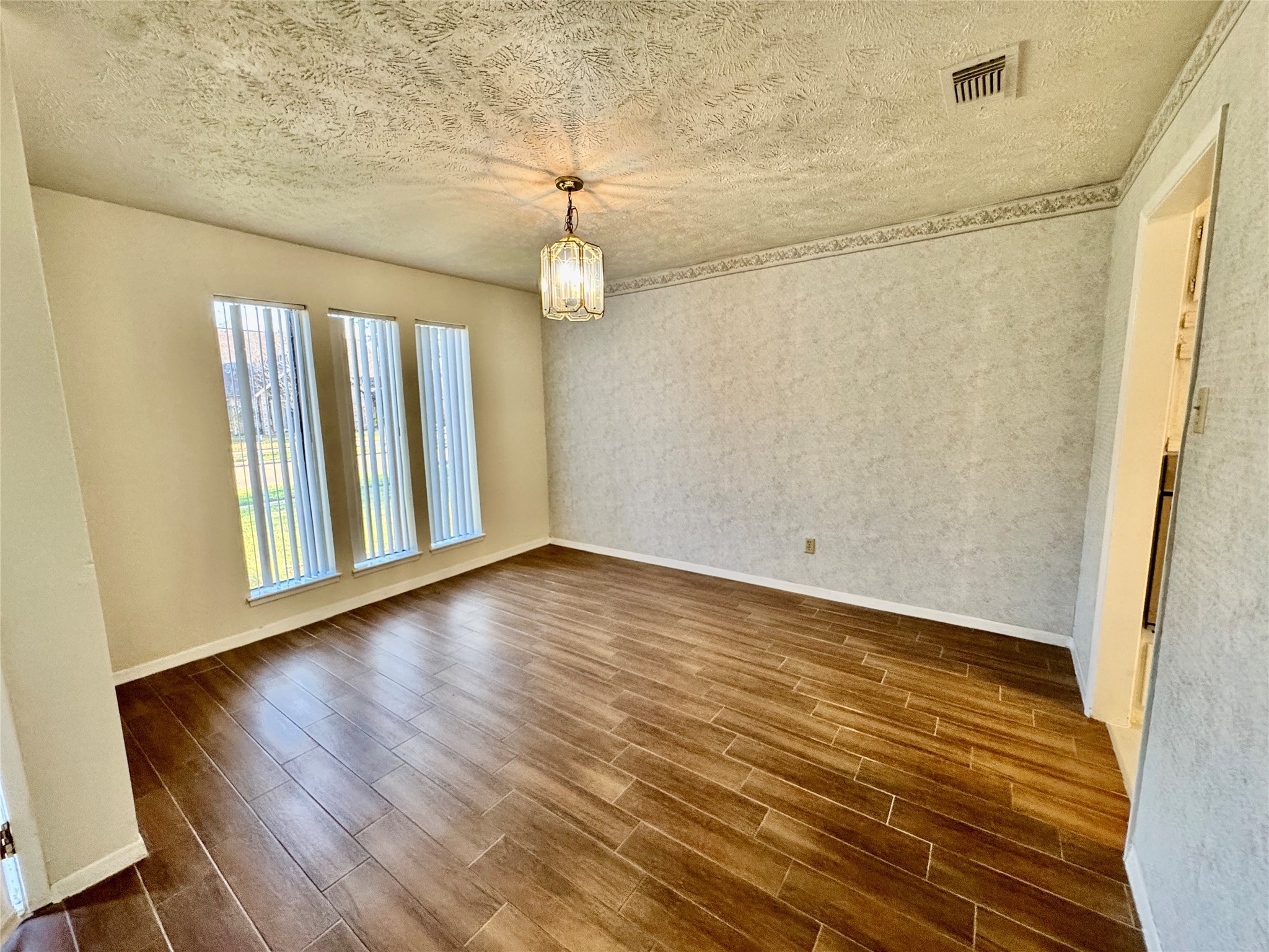 10131 Sagedale Drive Houston, TX 77089 - Photo 6 of 21 a view of an empty room with wooden floor and a window