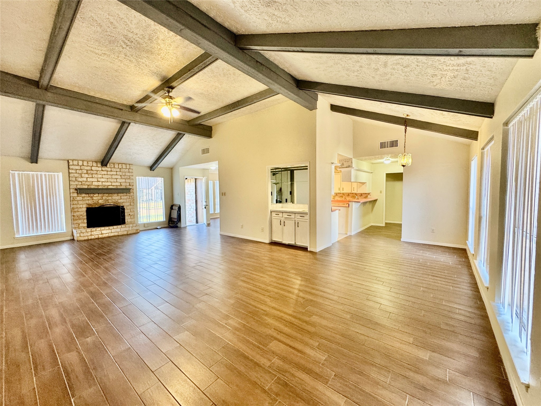 10131 Sagedale Drive Houston, TX 77089 - Photo 7 of 21 a view of an empty room with wooden floor fireplace and a window
