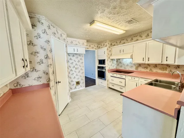 a kitchen with stainless steel appliances a refrigerator and a stove