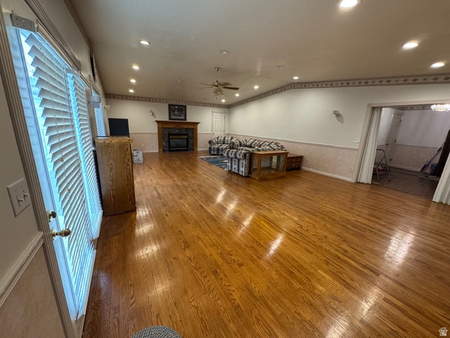 588 North 4500 West West Point, UT 84015 - Photo 8 of 61 Living area featuring, wood finished floors, a glass covered fireplace, recessed lighting, and ceiling fan