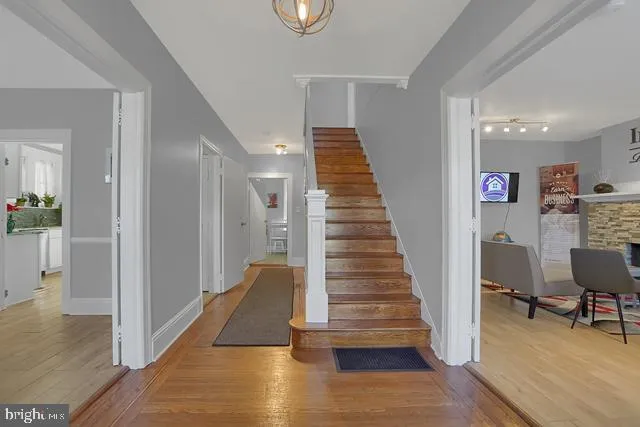 a view of entryway and hall with wooden floor
