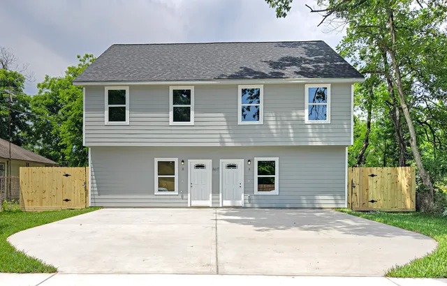 a house that has a tree in front of it