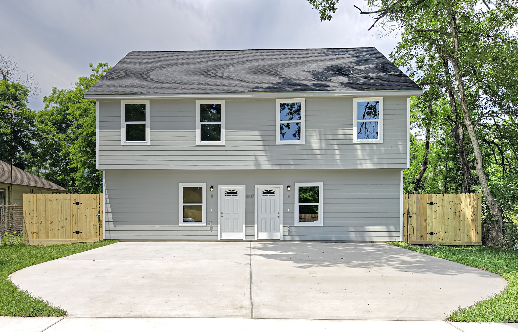 a house that has a tree in front of it