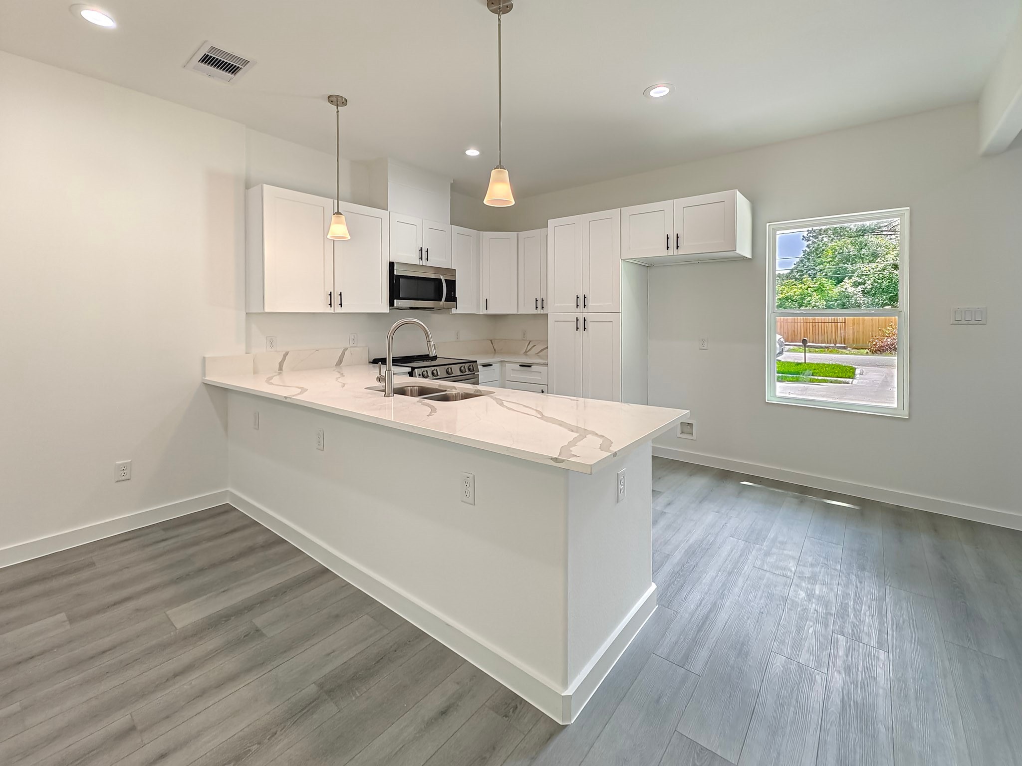 8617 Hoffman Street, Unit B Houston, TX 77016 - Photo 13 of 13 a kitchen with a sink a stove a refrigerator and a window