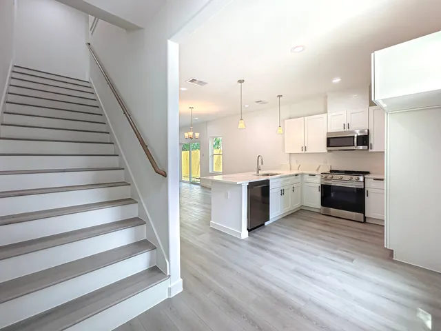 a view of kitchen with sink microwave and stove