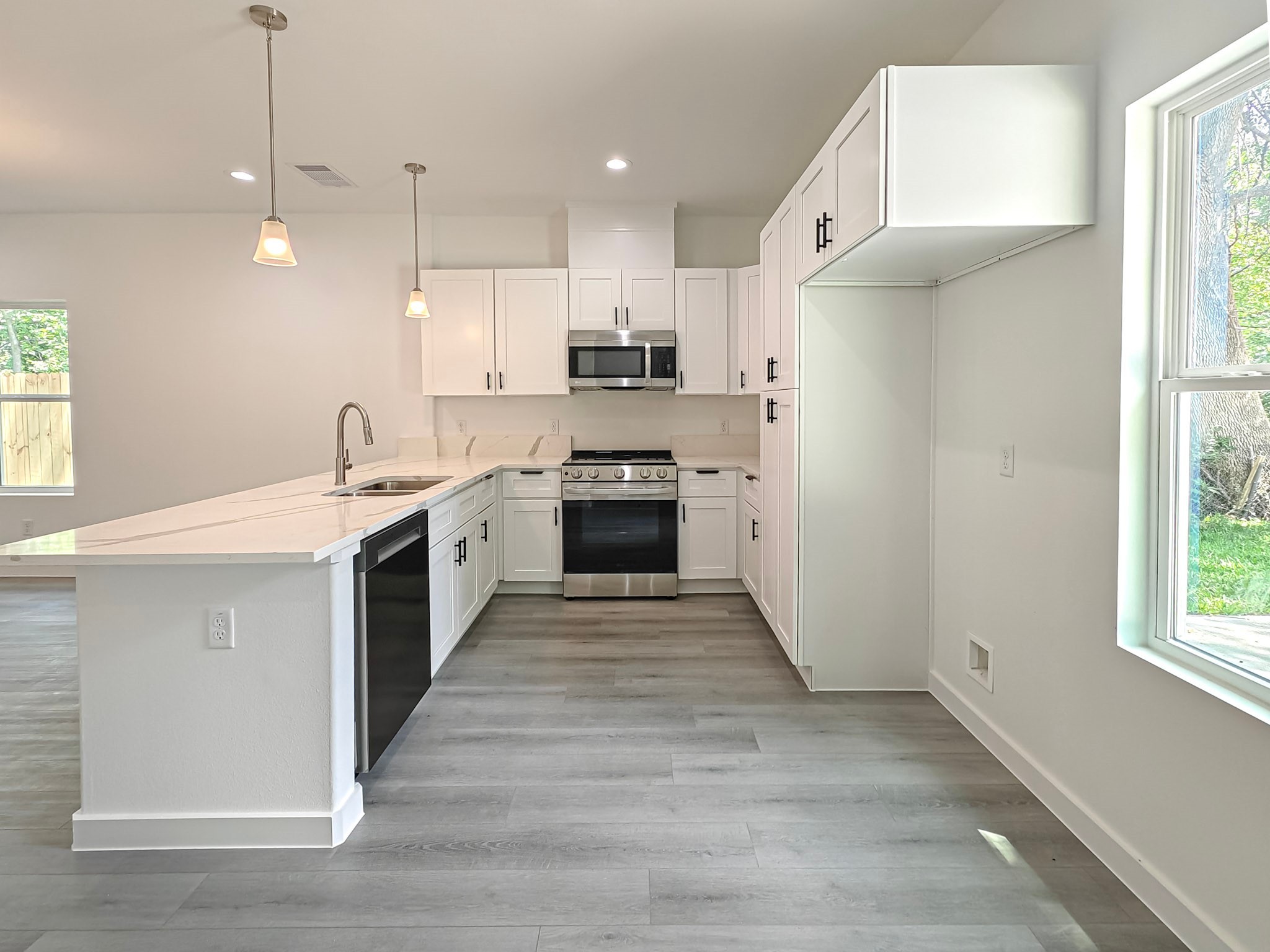8617 Hoffman Street, Unit B Houston, TX 77016 - Photo 3 of 13 a kitchen with stainless steel appliances granite countertop a sink stove and a refrigerator