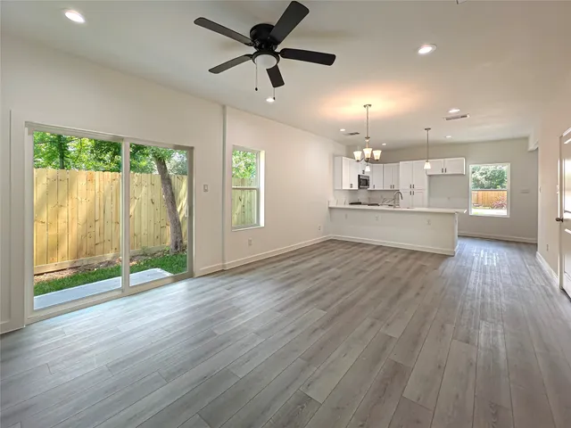 a view of a kitchen with a sink and wooden floor