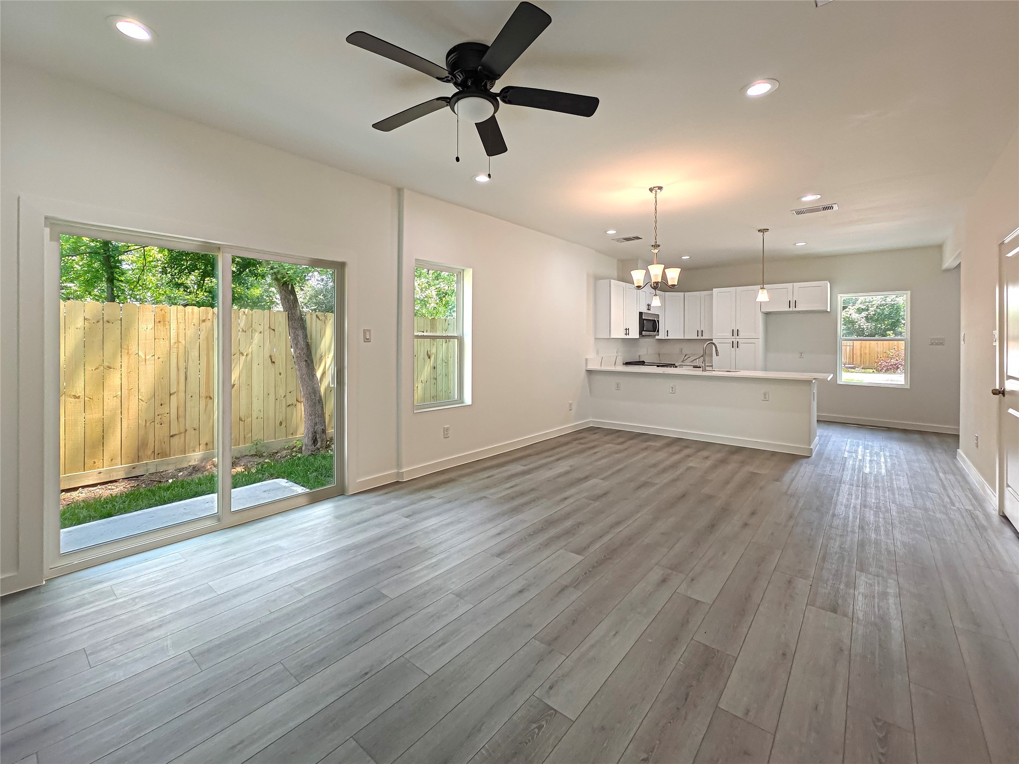 8617 Hoffman Street, Unit B Houston, TX 77016 - Photo 5 of 13 a view of a kitchen with a sink and wooden floor