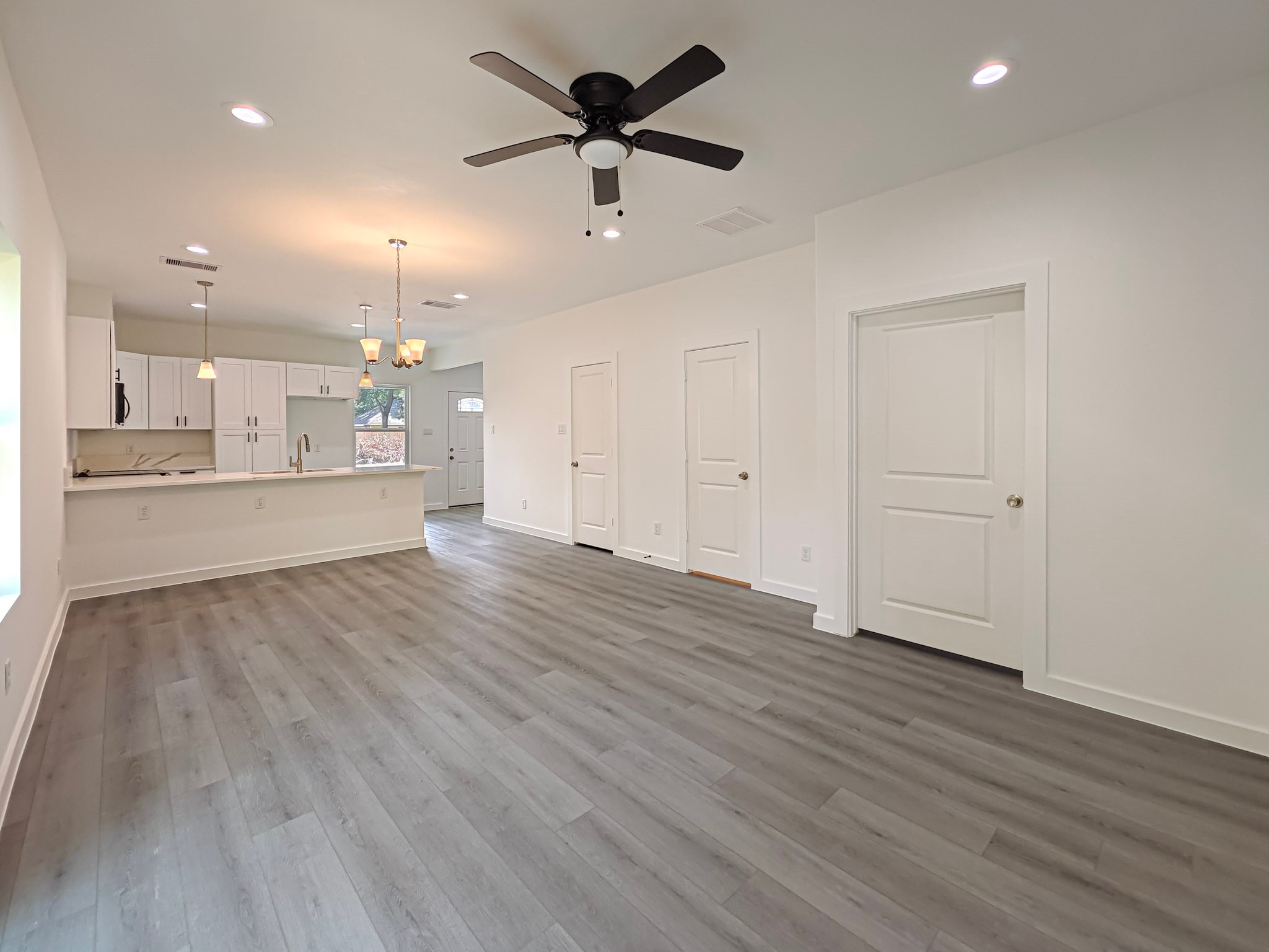 8617 Hoffman Street, Unit B Houston, TX 77016 - Photo 9 of 13 an empty room with wooden floor and windows