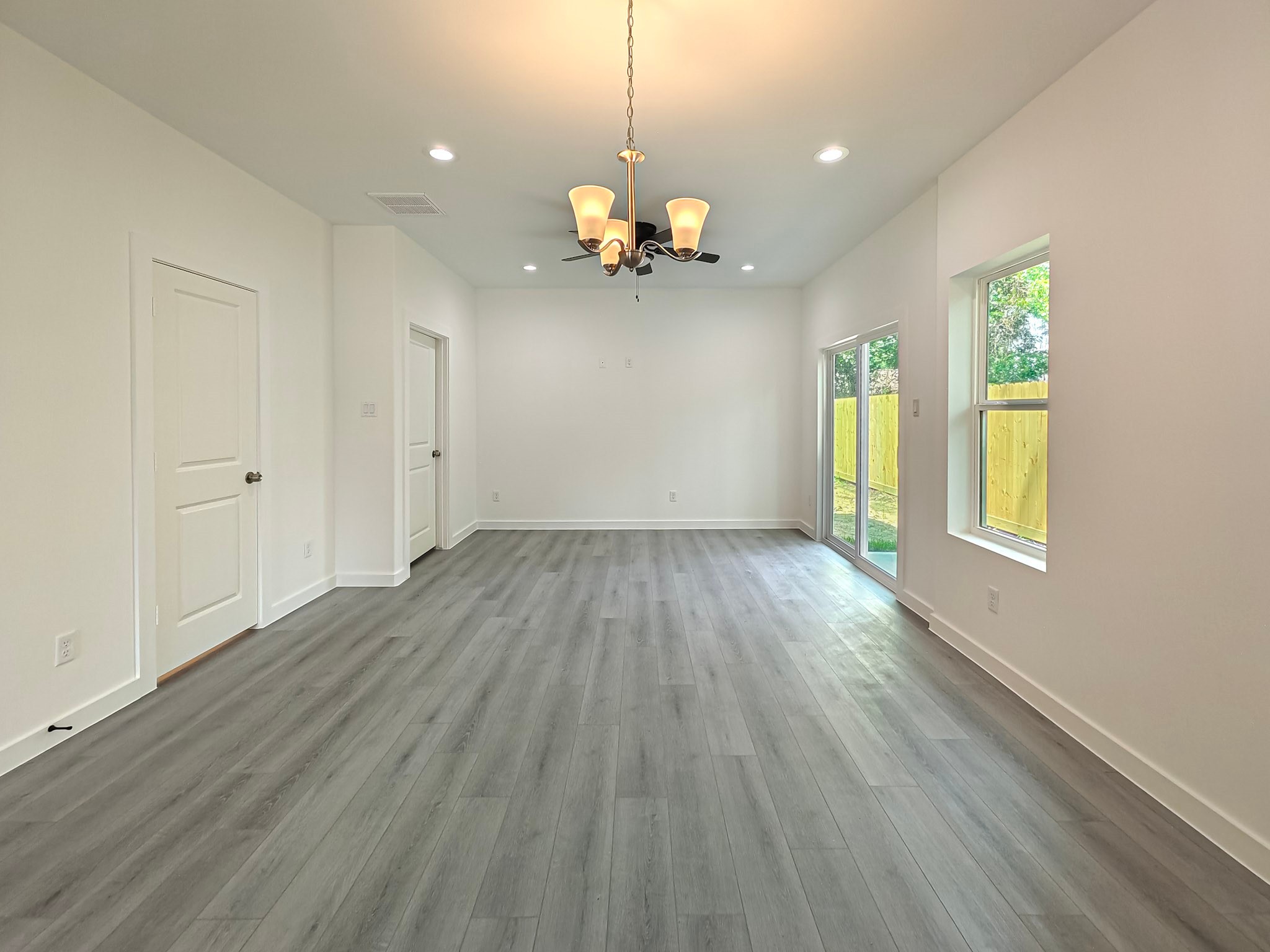 8617 Hoffman Street, Unit B Houston, TX 77016 - Photo 10 of 13 a view of an empty room with window and wooden floor