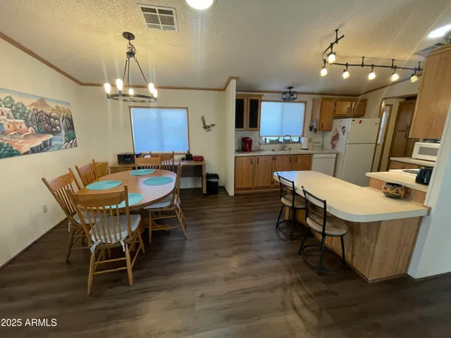 a dining room with furniture and wooden floor