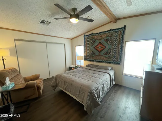 a bedroom with a bed and a painting on the wall