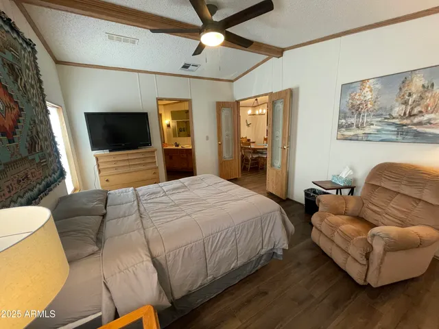 a bedroom with a bed couch and a flat screen tv