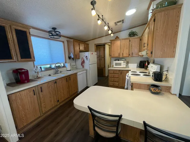 a kitchen with a sink appliances and cabinets