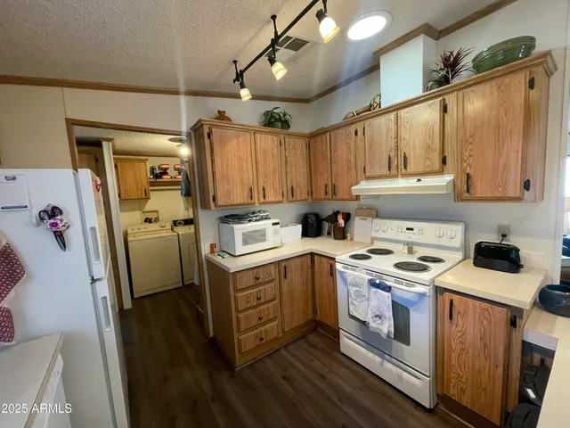 a kitchen with a stove sink and cabinets
