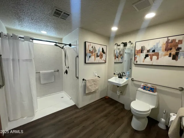 a bathroom with a toilet sink and mirror