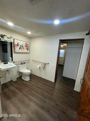 a bathroom with a toilet a sink and a mirror
