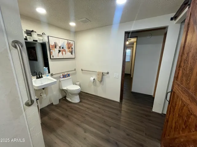 a bathroom with a toilet sink and shower
