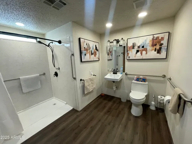 a bathroom with a toilet sink and shower