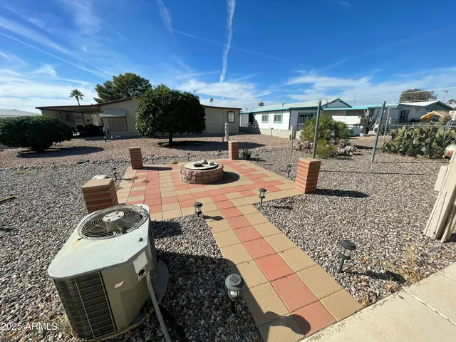 a view of a house with backyard and sitting area