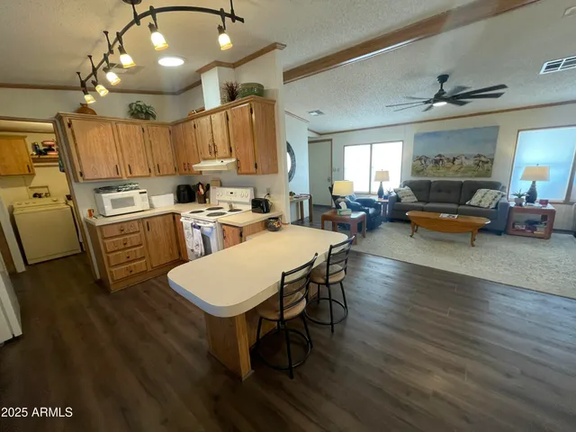 a open kitchen with sink cabinets and wooden floor