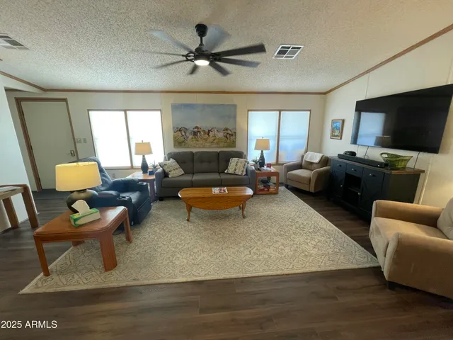 a living room with furniture wooden floor and a flat screen tv