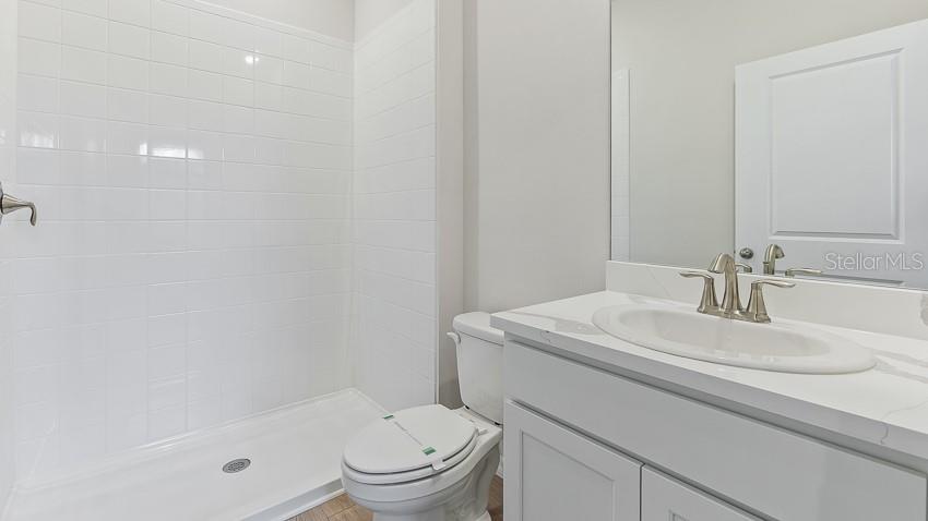 1925 Cobb Trail Parrish, FL 34219 - Photo 17 of 25 a bathroom with a sink toilet vanity and shower