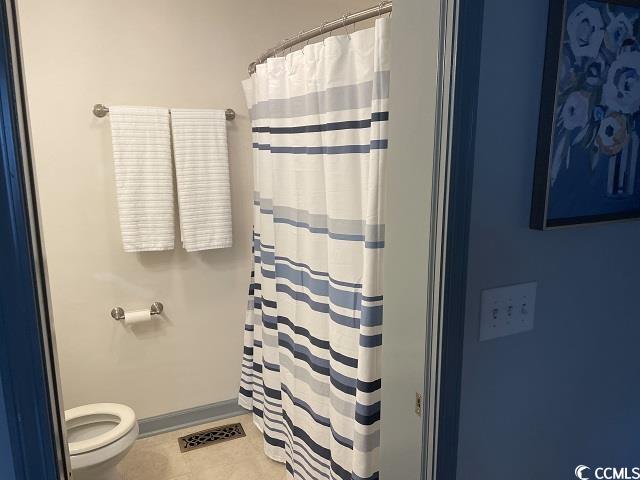414 36th Avenue North Myrtle Beach, SC 29577 - Photo 11 of 22 Bathroom featuring a shower with curtain and light tile patterned flooring