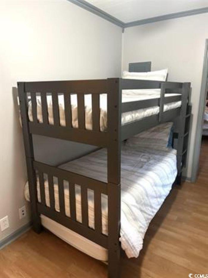414 36th Avenue North Myrtle Beach, SC 29577 - Photo 12 of 22 Bedroom with light wood-style flooring and crown molding