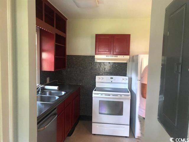 414 36th Avenue North Myrtle Beach, SC 29577 - Photo 16 of 22 Kitchen with dark brown cabinets, stainless steel appliances, dark countertops, tile walls, and open shelves