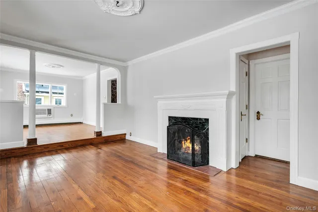 a view of a livingroom with wooden floor and a fireplace