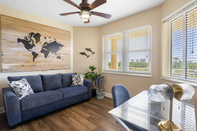 a living room with furniture and wooden floor