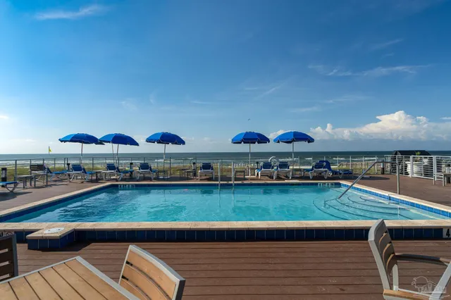 a view of swimming pool with outdoor seating